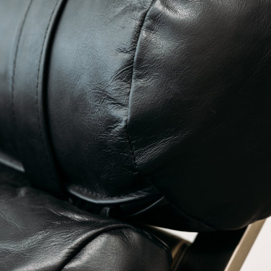 Close up of Angus Leather Chair with matching Leather Ottoman in Oxford Black